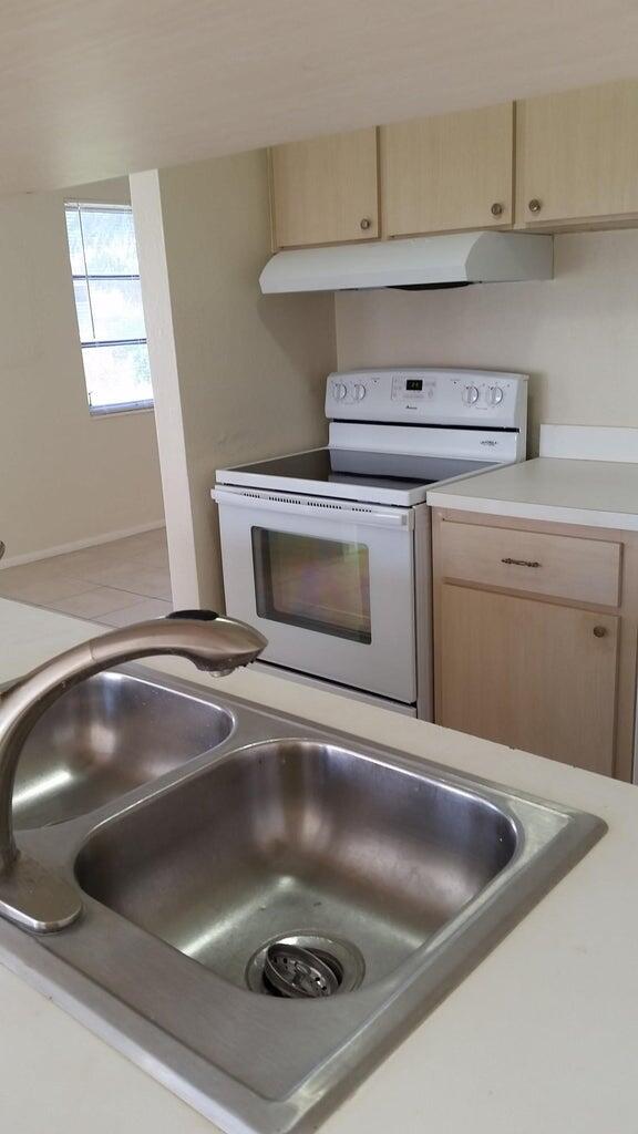 1230 West 23rd Street Riviera Beach, FL 33404 - Photo 7 of 19 a close view of sink and stove