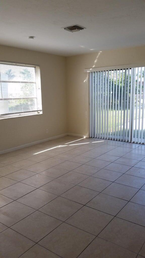 1230 West 23rd Street Riviera Beach, FL 33404 - Photo 8 of 19 a view of an empty room with a window