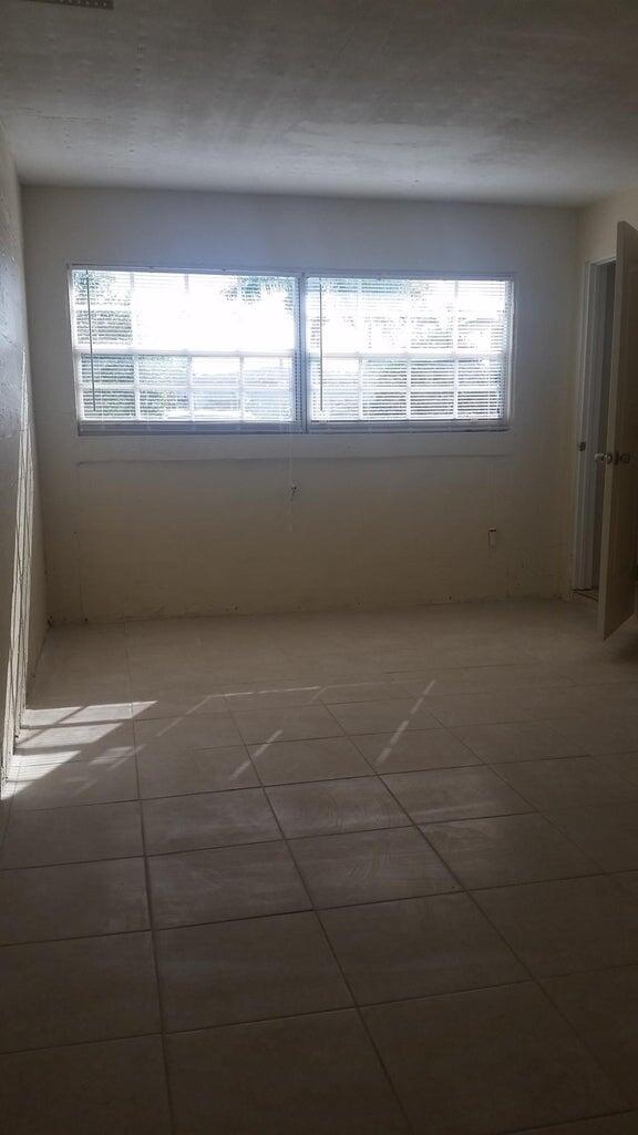 1230 West 23rd Street Riviera Beach, FL 33404 - Photo 10 of 19 a view of an empty room with a window