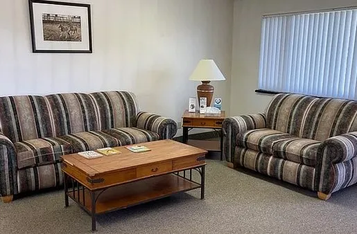 a bedroom with furniture and a lamp