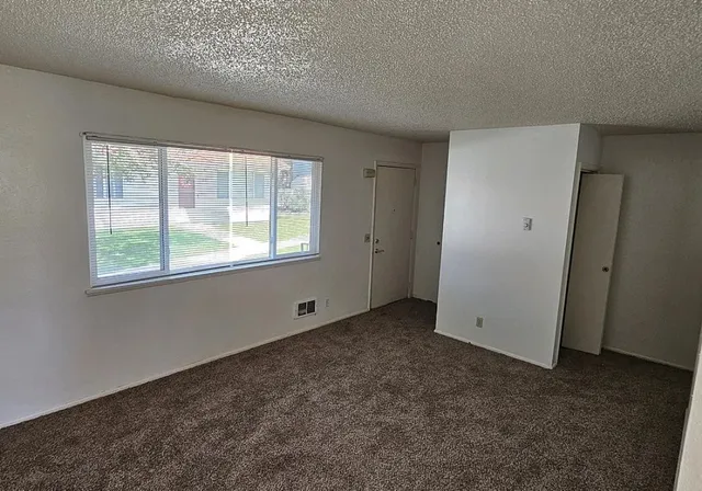 a view of an empty room with a window