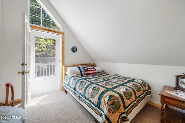 a bedroom with bed and wooden floor