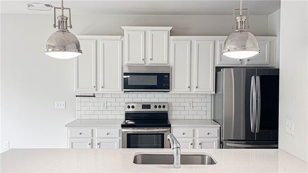 740 Eudora Welty Way Athens, GA 30607 - Photo 13 of 57 a kitchen with a sink a stove and refrigerator