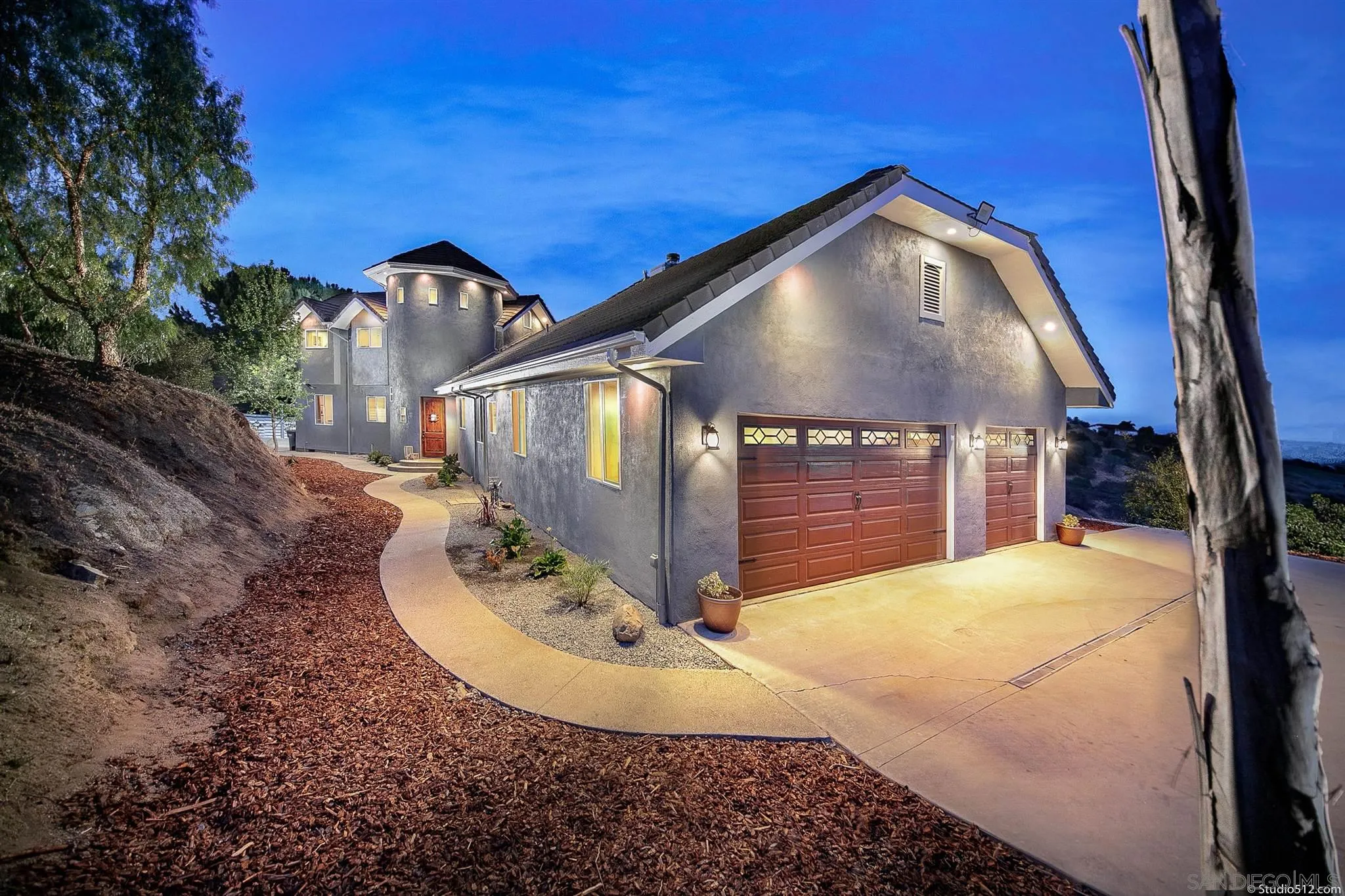 a view of a house with a small backyard