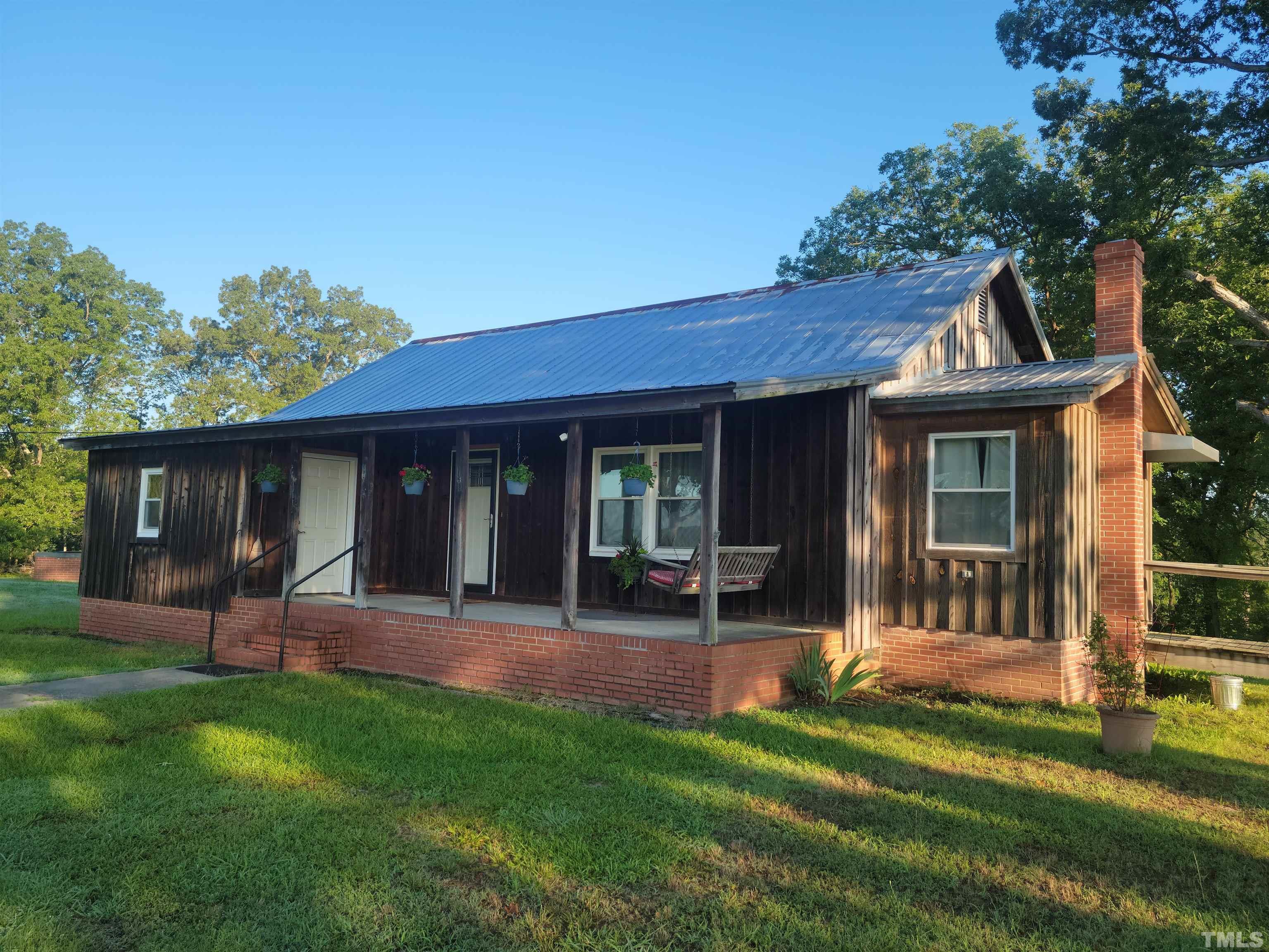 a front view of a house with a garden and porch