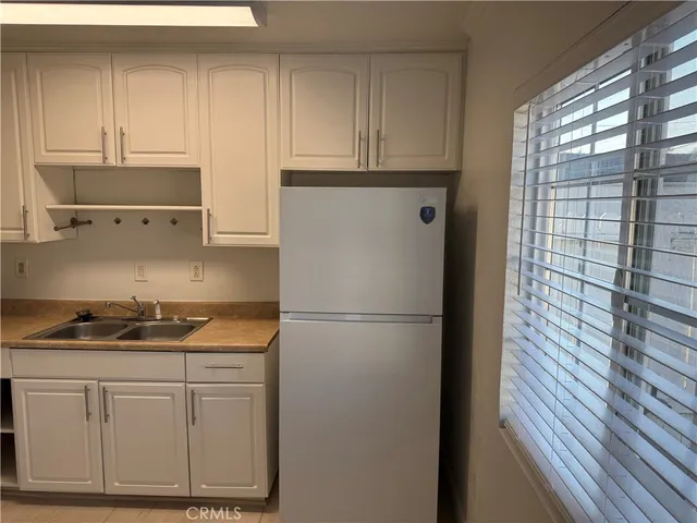 a kitchen with appliances cabinets and a sink