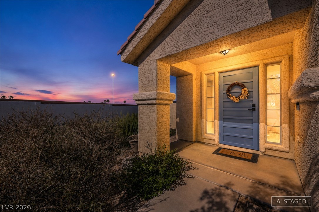1900 Cardinal Point Street Henderson, NV 89012 - Photo 6 of 32 An inviting front entry welcomes you home, casting a warm glow against the twilight sky.