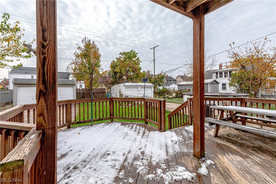 3337 Ralph Avenue Cleveland, OH 44109 - Photo 29 of 30 Wooden deck featuring a garage, a storage shed, and a lawn