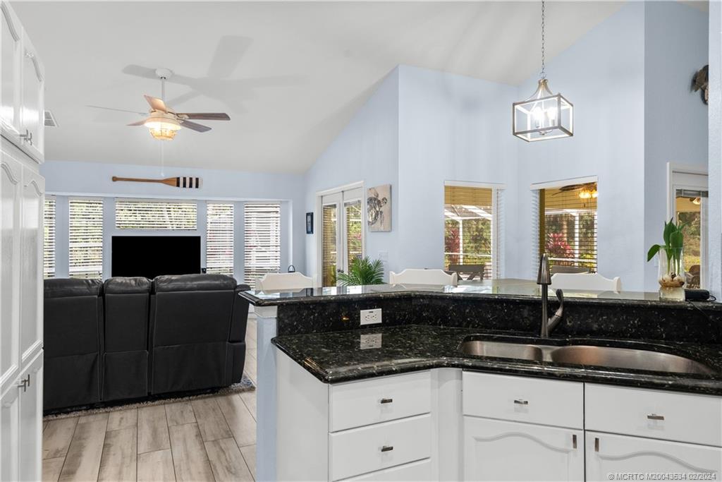 2457 Southeast Issac Road Port St. Lucie, FL 34952 - Photo 15 of 51 a kitchen with granite countertop a sink and cabinets