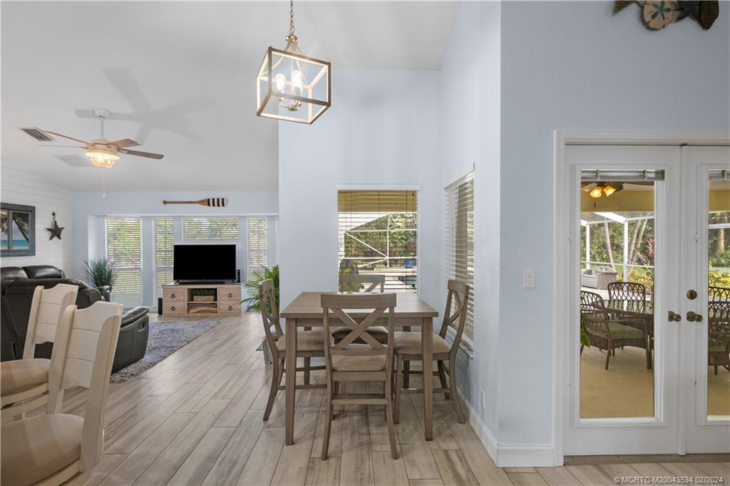 2457 Southeast Issac Road Port St. Lucie, FL 34952 - Photo 17 of 51 a view of a dining room with furniture window and wooden floor