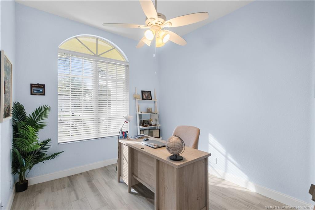 2457 Southeast Issac Road Port St. Lucie, FL 34952 - Photo 20 of 51 a view of room with window and wooden floor