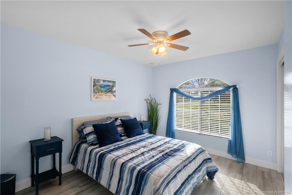 2457 Southeast Issac Road Port St. Lucie, FL 34952 - Photo 21 of 51 a bedroom with bed and a window