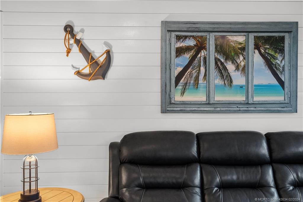 2457 Southeast Issac Road Port St. Lucie, FL 34952 - Photo 25 of 51 a living room with a couch and a table