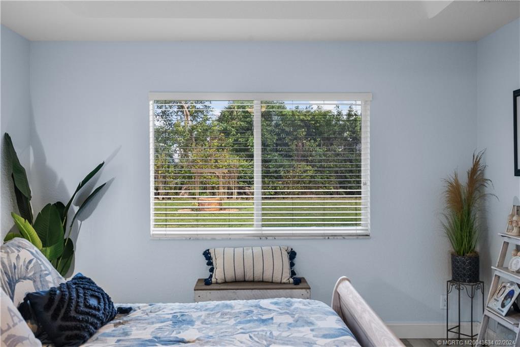 2457 Southeast Issac Road Port St. Lucie, FL 34952 - Photo 26 of 51 a bedroom with a bed and a window