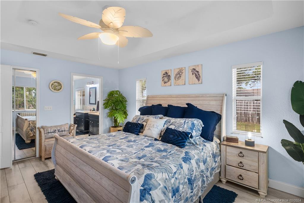 2457 Southeast Issac Road Port St. Lucie, FL 34952 - Photo 27 of 51 a bedroom with a bed potted plant on the dresser and a window