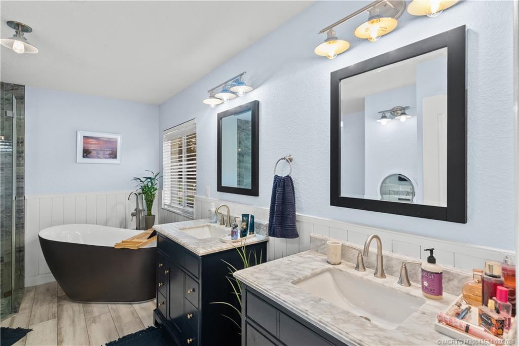 2457 Southeast Issac Road Port St. Lucie, FL 34952 - Photo 28 of 51 a bathroom with a granite countertop sink and a mirror