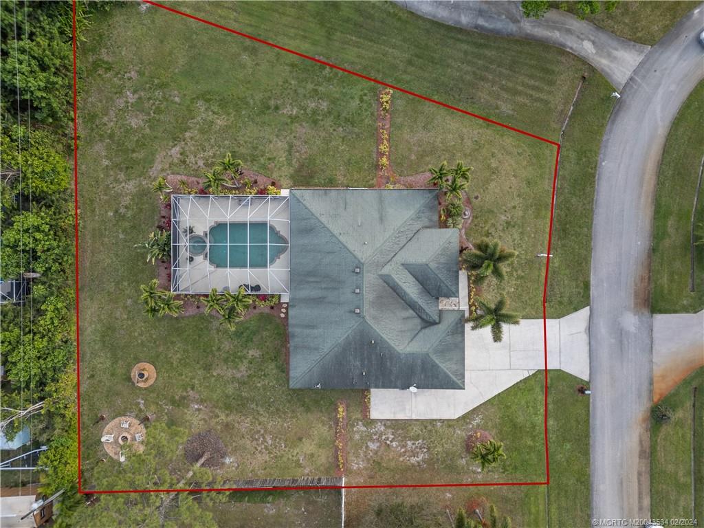 2457 Southeast Issac Road Port St. Lucie, FL 34952 - Photo 31 of 51 an aerial view of a house with a yard
