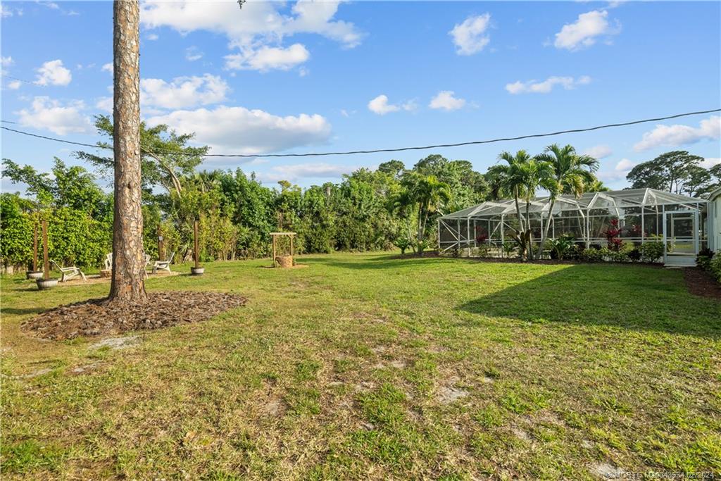 2457 Southeast Issac Road Port St. Lucie, FL 34952 - Photo 39 of 51 a view of a garden with a building in the background