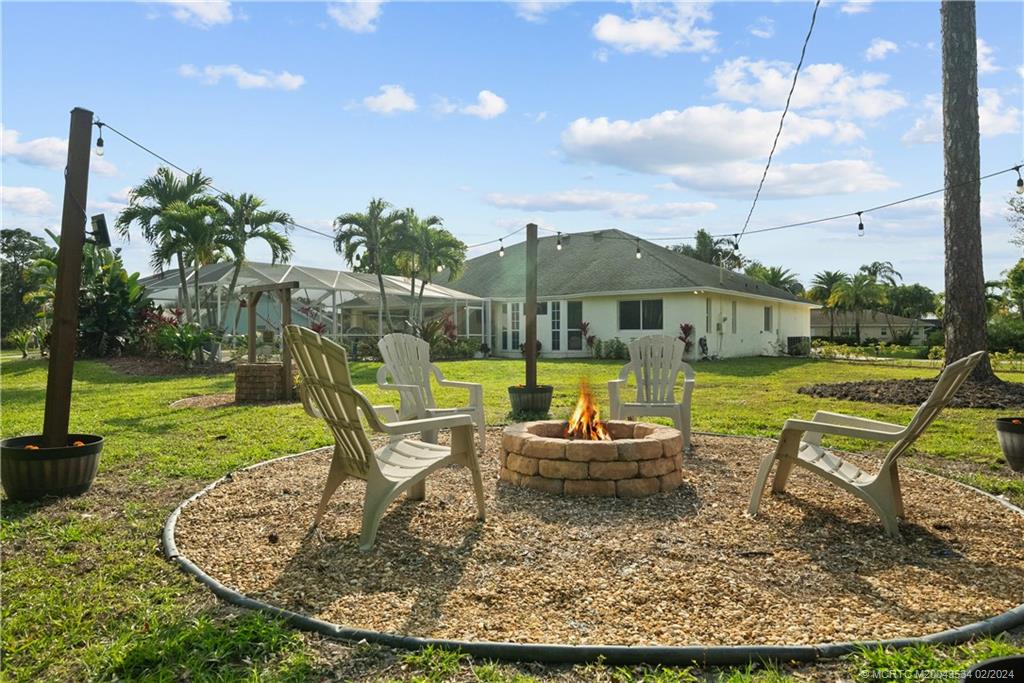 2457 Southeast Issac Road Port St. Lucie, FL 34952 - Photo 41 of 51 a view of a house with backyard porch and sitting area