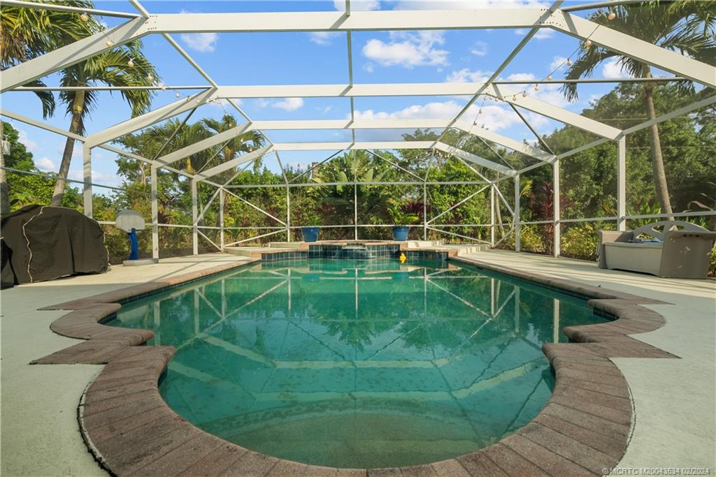 2457 Southeast Issac Road Port St. Lucie, FL 34952 - Photo 45 of 51 a view of a swimming pool with a patio
