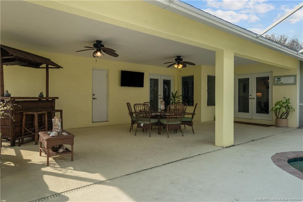 2457 Southeast Issac Road Port St. Lucie, FL 34952 - Photo 47 of 51 a view of living room kitchen with table and chairs