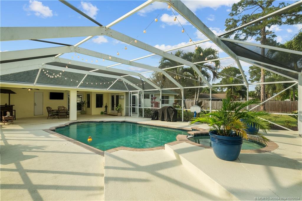 2457 Southeast Issac Road Port St. Lucie, FL 34952 - Photo 49 of 51 a view of a swimming pool with a patio
