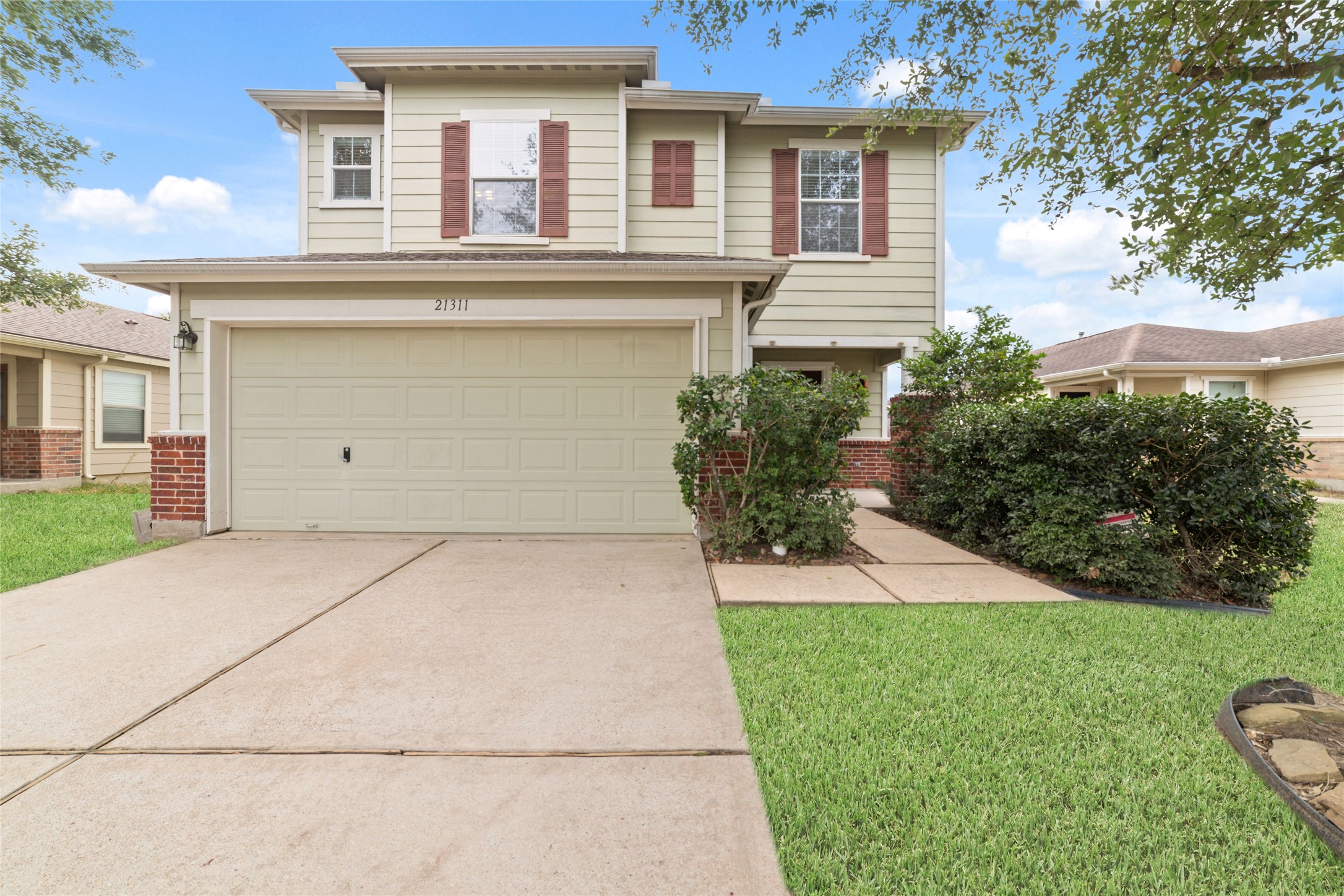 21311 Shadow River Lane Spring, TX 77379 - Photo 7 of 38 a front view of a house with a garden