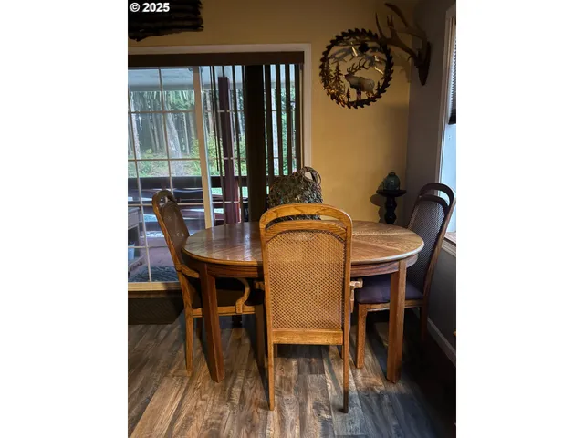 a dining room with furniture and wooden floor