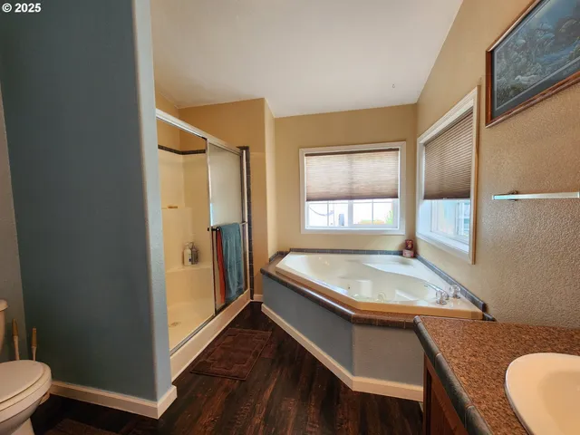 a bathroom with a granite countertop sink toilet and shower
