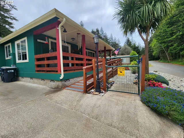 front view of a house with a yard and potted plants
