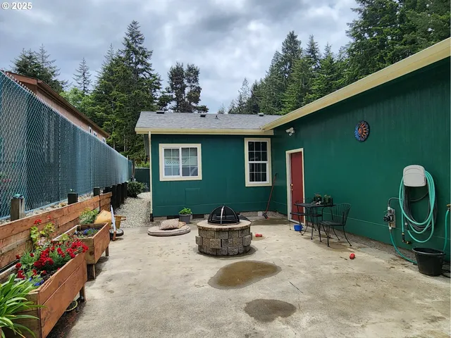 a view of a chairs and table in backyard