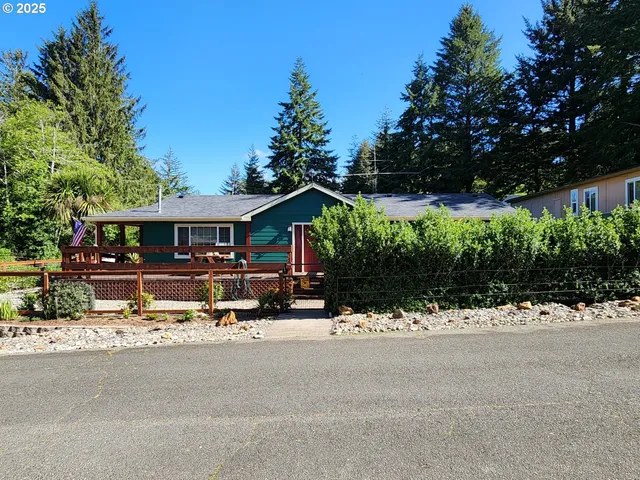 a view of house with yard and tree in front of it