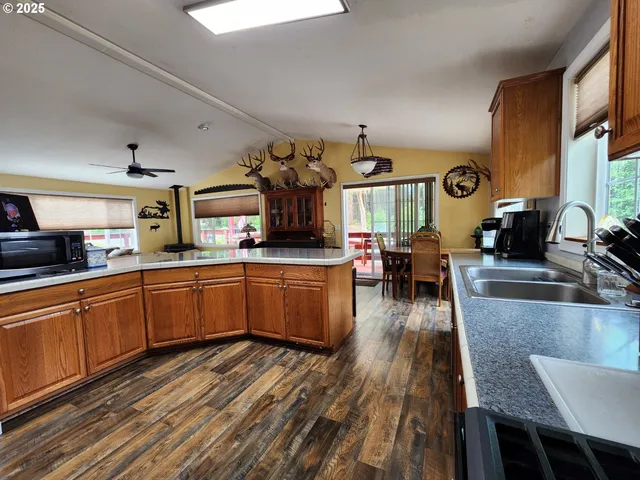 a kitchen with lots of counter top space and wooden floor