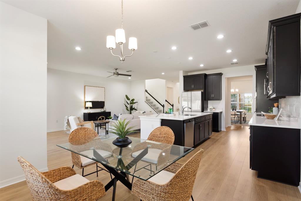 11127 Sundrift Drive Tampa, FL 33647 - Photo 14 of 44 a kitchen with stainless steel appliances kitchen island granite countertop a stove a sink a refrigerator and chairs