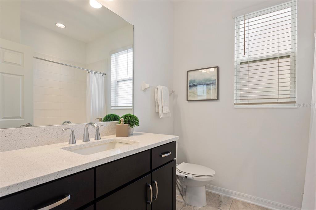 11127 Sundrift Drive Tampa, FL 33647 - Photo 19 of 44 a bathroom with a sink a toilet and mirror