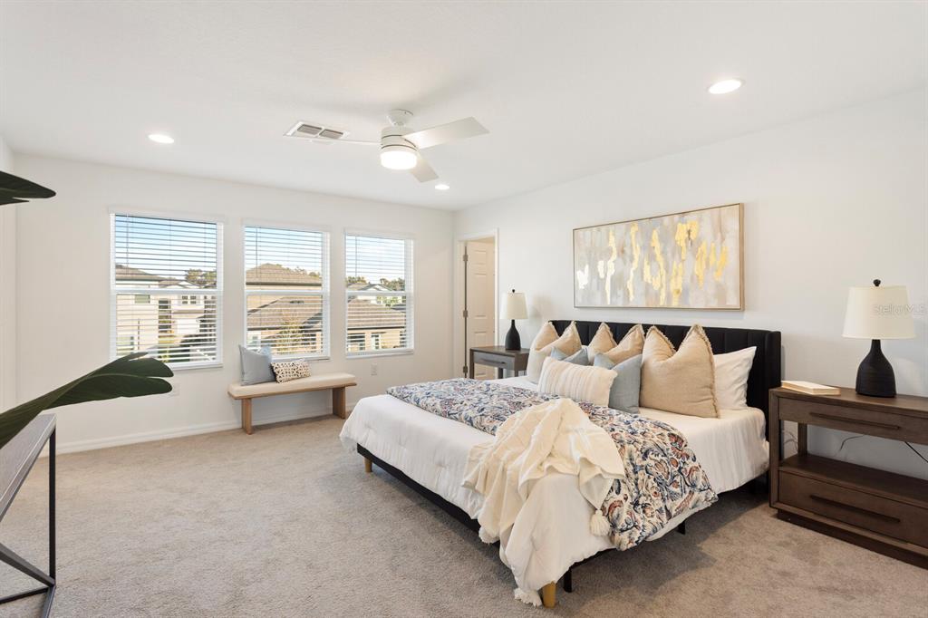 11127 Sundrift Drive Tampa, FL 33647 - Photo 24 of 44 a spacious bedroom with a bed and a large window