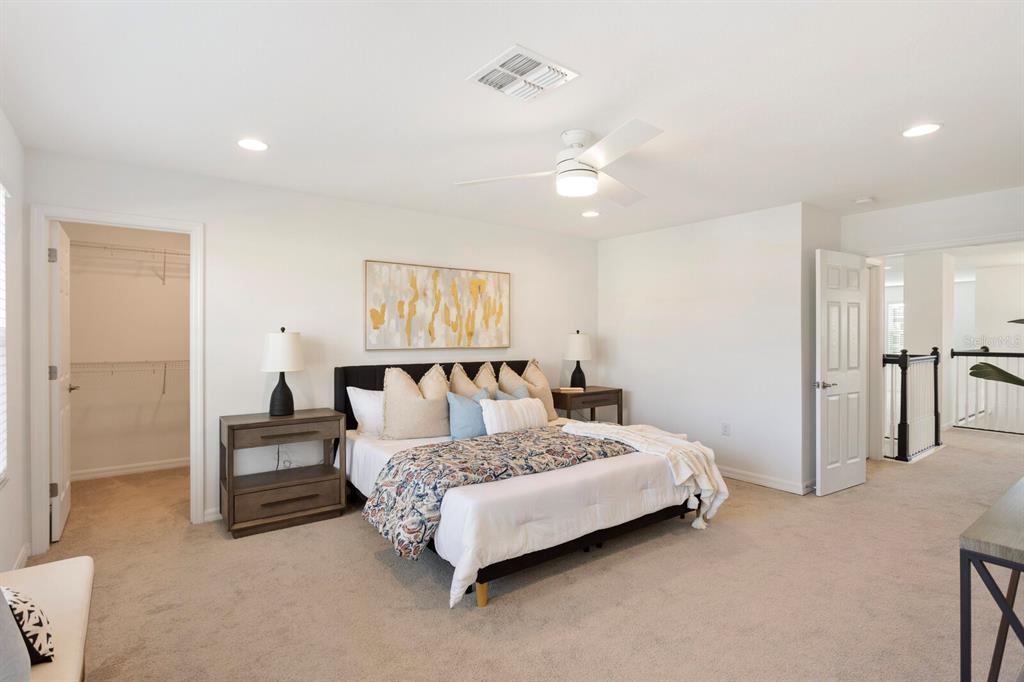 11127 Sundrift Drive Tampa, FL 33647 - Photo 25 of 44 a bed room with a bed and a chandelier
