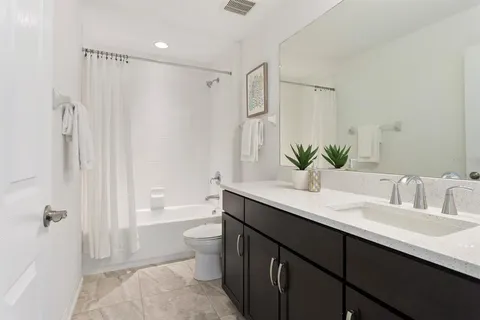 an aerial view of a swimming pool with lawn chairs and large trees