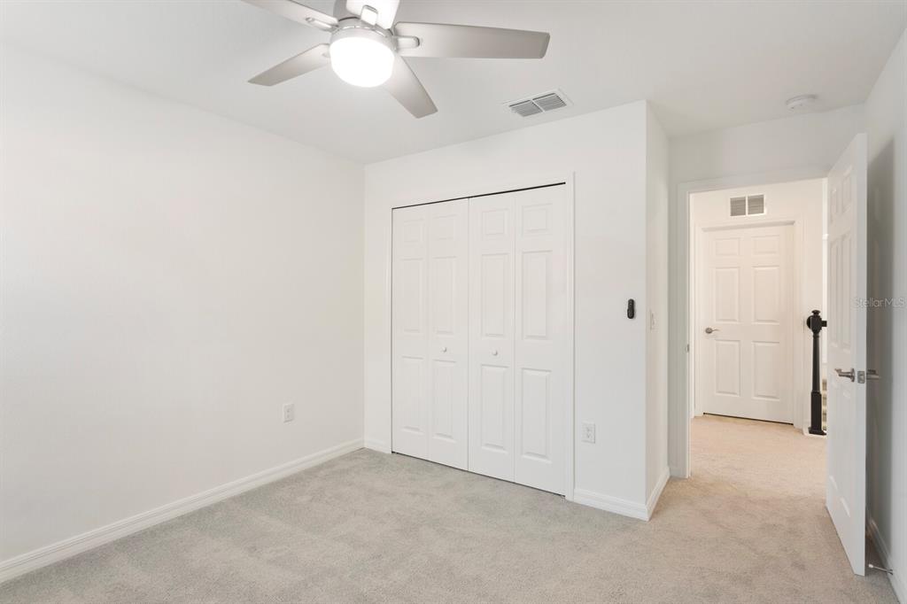 11127 Sundrift Drive Tampa, FL 33647 - Photo 35 of 44 an empty room with closet and a chandelier fan