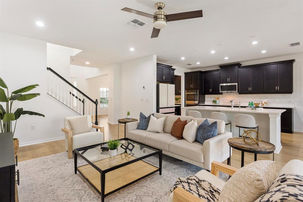 11127 Sundrift Drive Tampa, FL 33647 - Photo 6 of 44 a living room with furniture kitchen view and a wooden floor