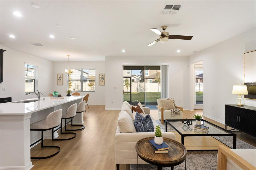 11127 Sundrift Drive Tampa, FL 33647 - Photo 8 of 44 a living room with furniture a window and a chandelier