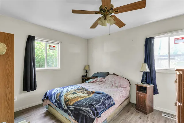 a bedroom with a bed and a window