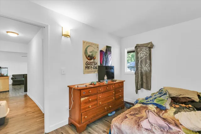 a bed room with a bed and a dresser