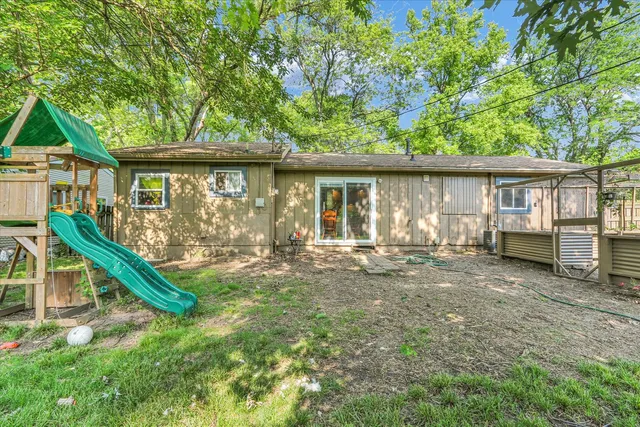 a view of a house with backyard porch and sitting area