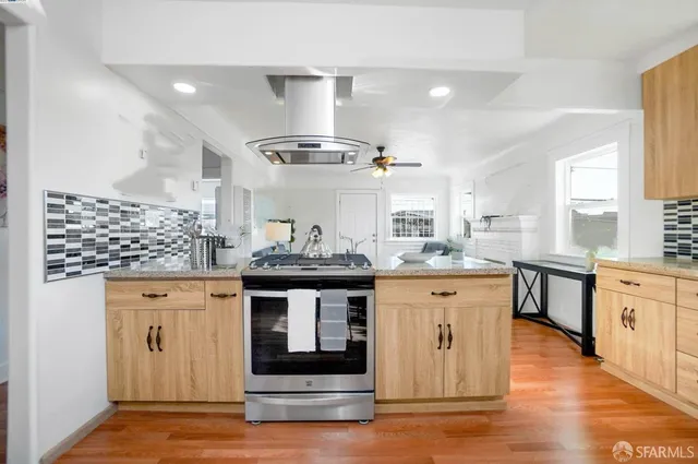 a kitchen with stainless steel appliances granite countertop a stove and cabinets