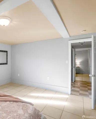 a view of a hallway to room with wooden floor