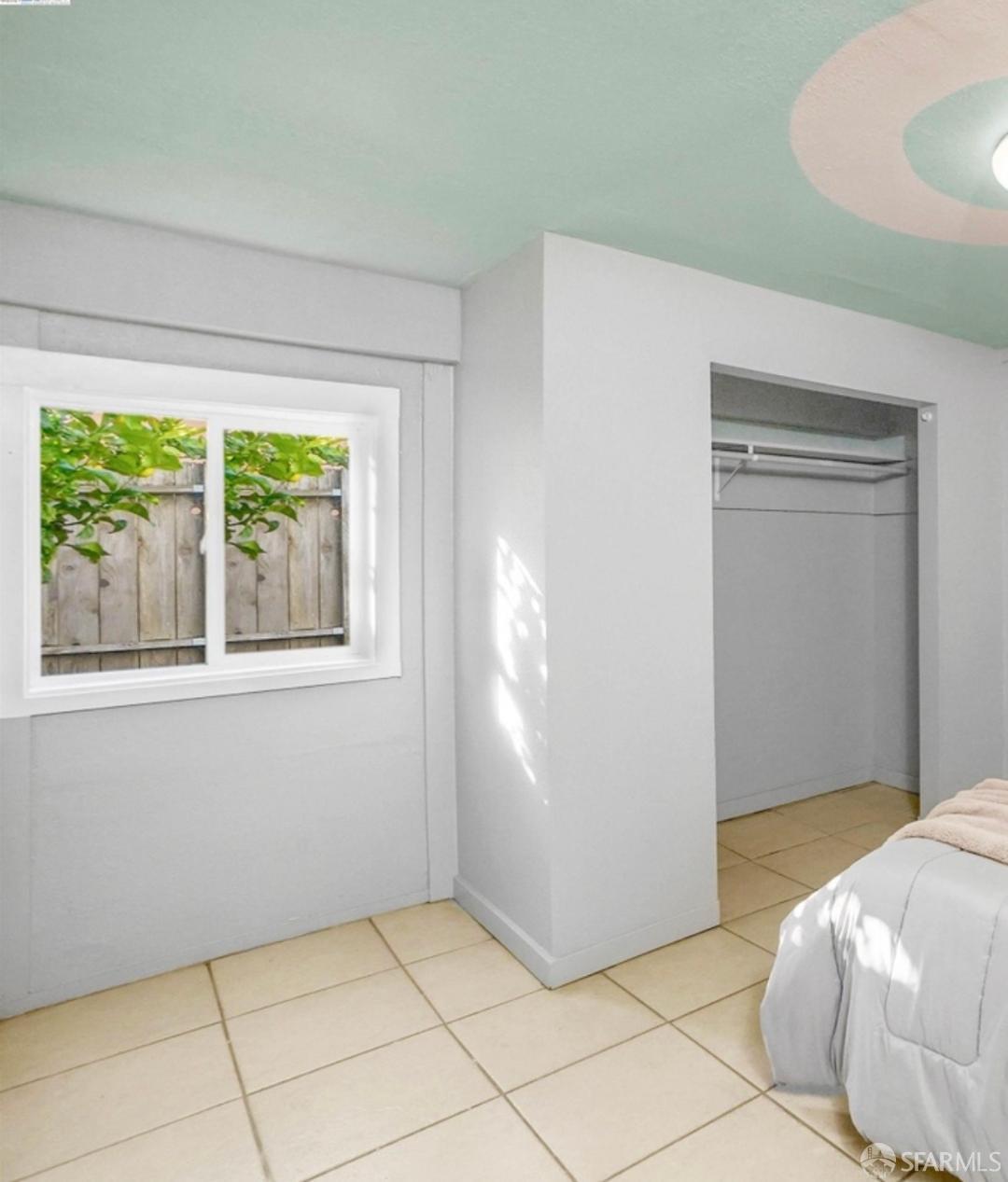 125 7th Street Richmond, CA 94801 - Photo 7 of 11 a bedroom with a bed and a window