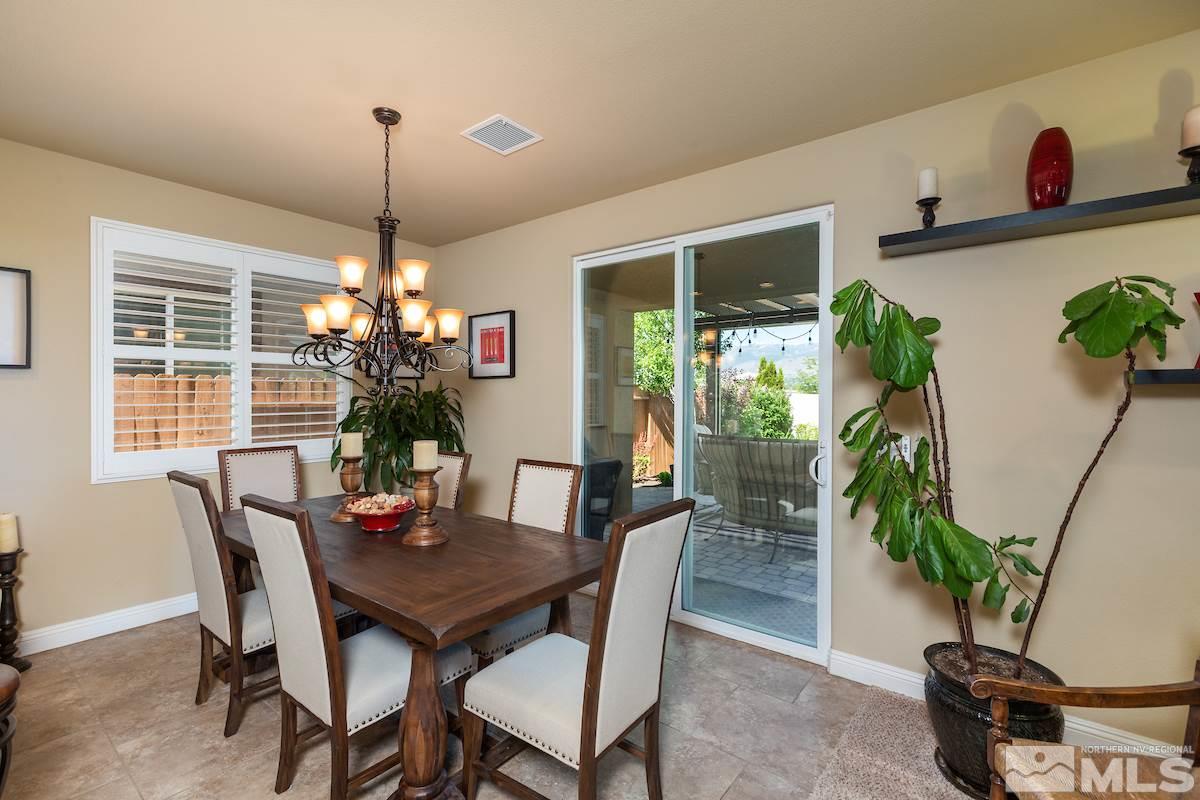 10701 Cordero Drive Reno, NV 89521 - Photo 11 of 25 a dining room with furniture potted plants and wooden floor