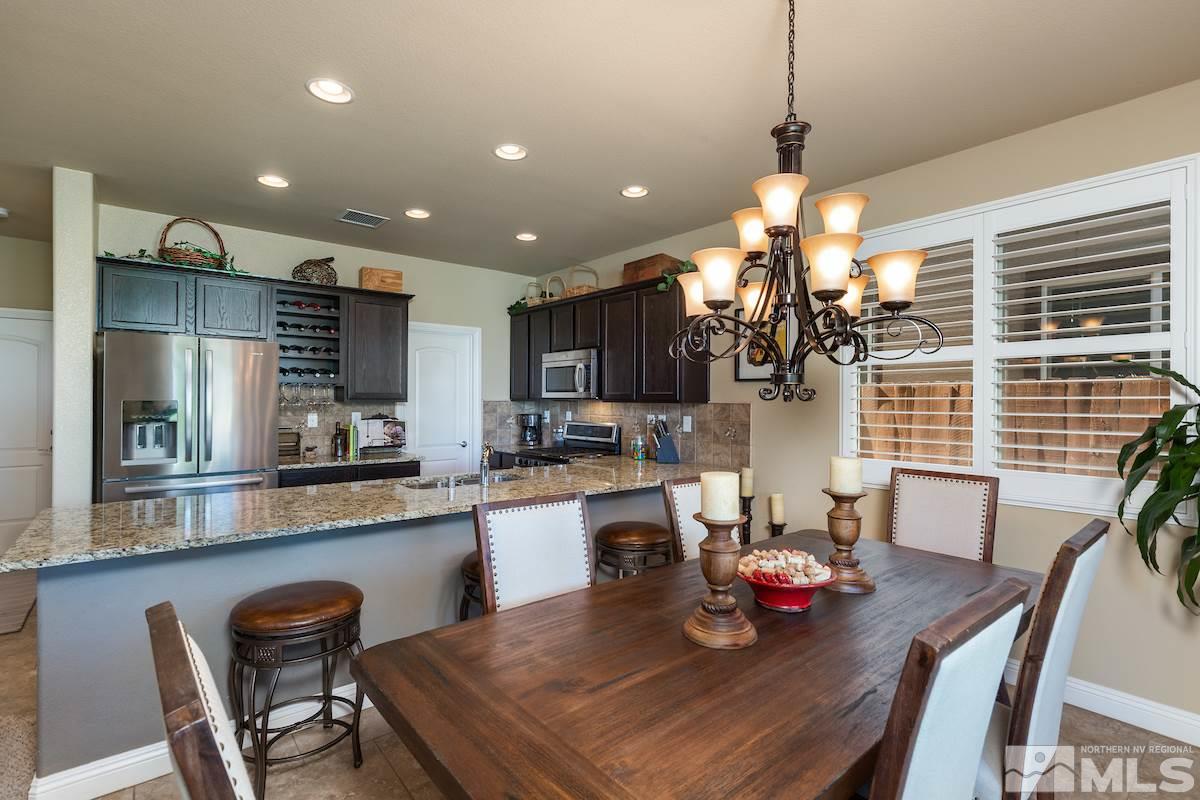 10701 Cordero Drive Reno, NV 89521 - Photo 12 of 25 a view of a dining room and livingroom with furniture wooden floor a chandelier