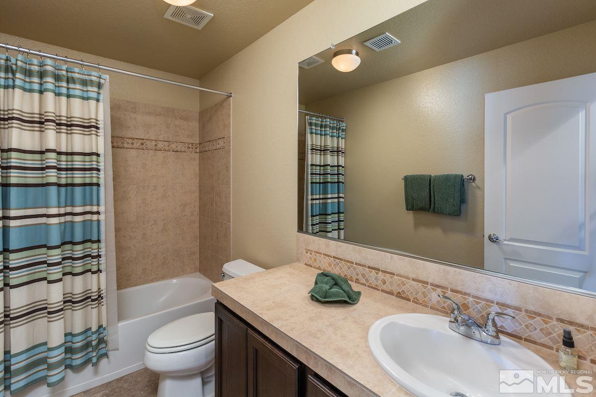 10701 Cordero Drive Reno, NV 89521 - Photo 20 of 25 a bathroom with a granite countertop sink toilet and shower